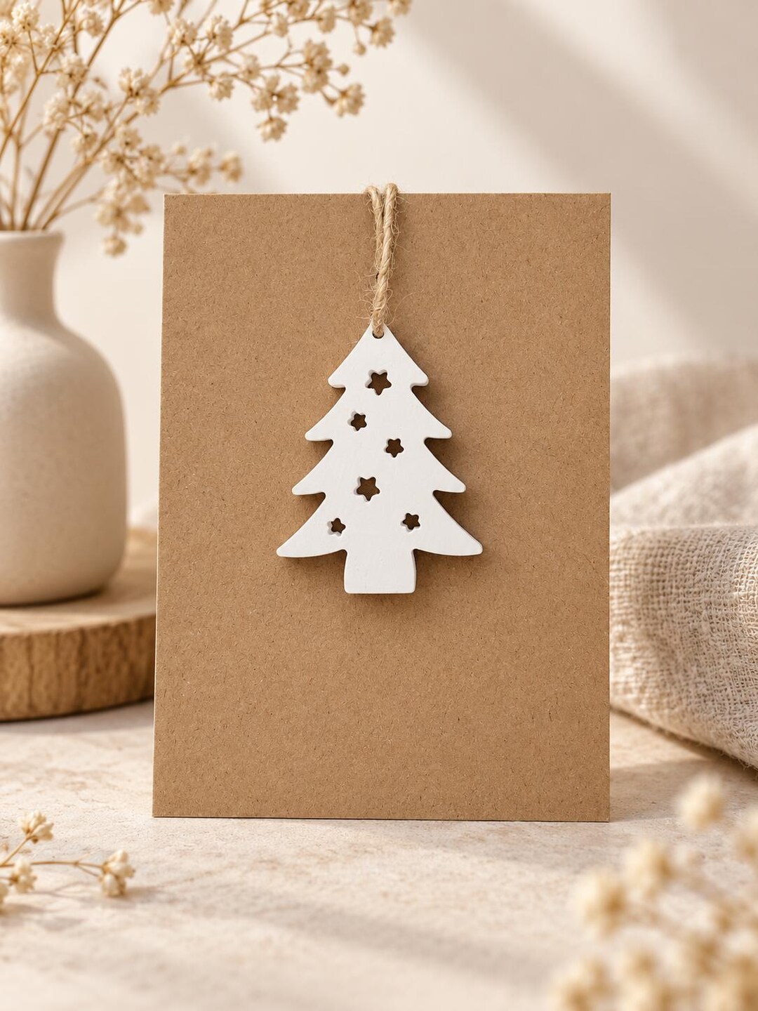Weißer Tannenbaum-Anhänger an Kraftpapierkarte